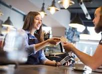 A customer paying at a restaurant checkout counter